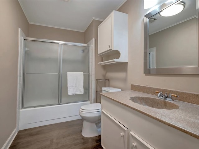 2600 Dogwood St, Nacogdoches, TX 75965 - full bath with wood finished floors, vanity, ornamental molding, and shower / bath combination with glass door