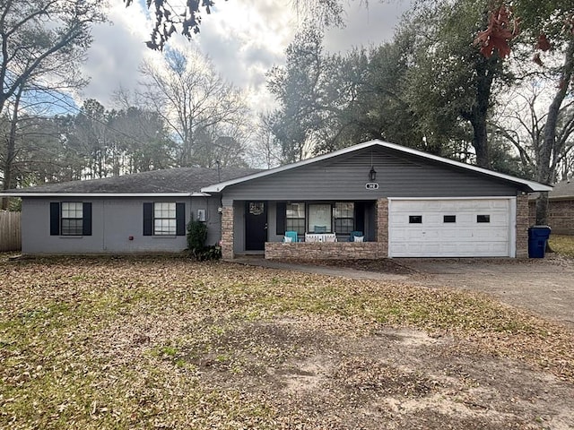 ranch-style house featuring an attached garage and dirt driveway