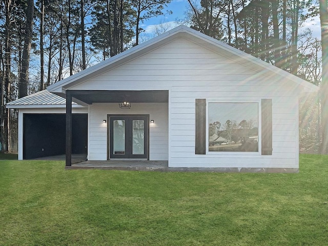 view of front of property with a front yard and french doors