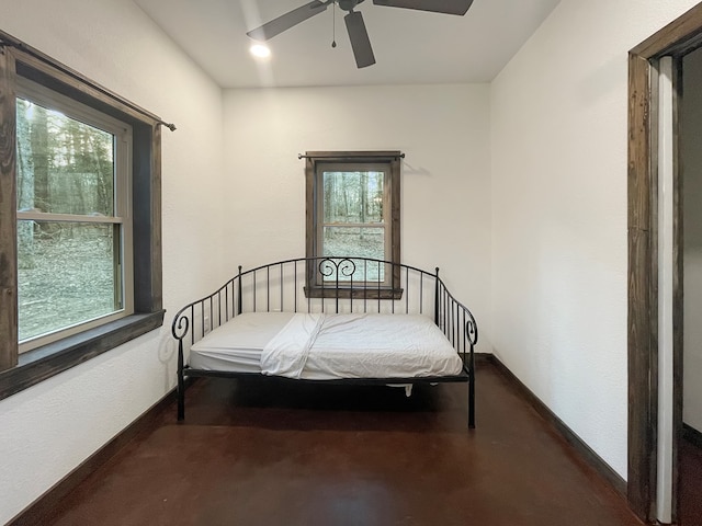 bedroom with concrete flooring and ceiling fan