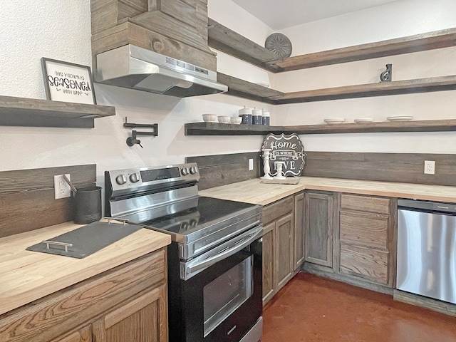 kitchen with wood counters and appliances with stainless steel finishes