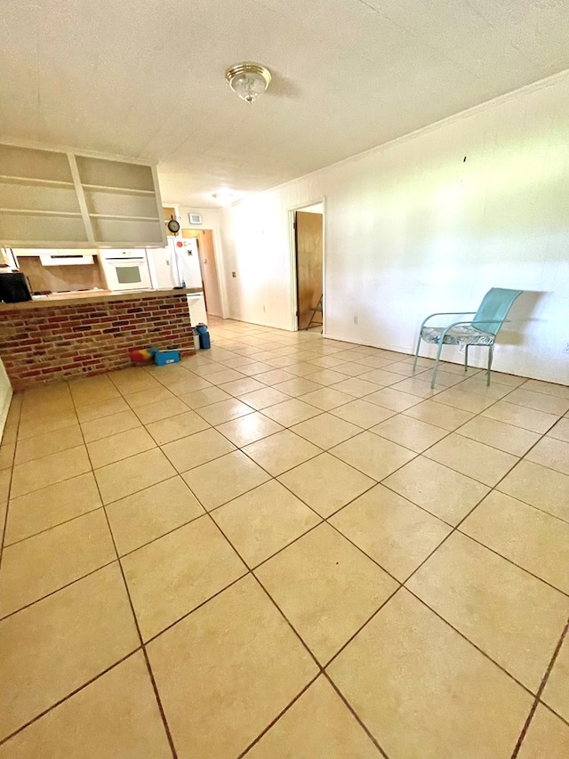 7203 Fm 326, Lufkin, TX 75901 - unfurnished living room with tile patterned flooring and a textured ceiling