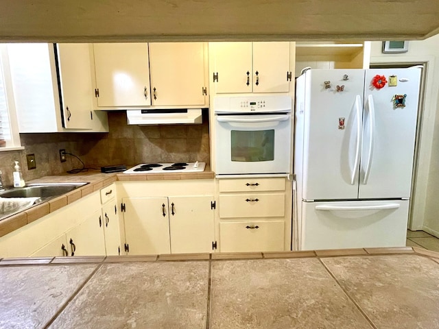 7203 Fm 326, Lufkin, TX 75901 - kitchen with white appliances, decorative backsplash, under cabinet range hood, tile countertops, and tile patterned flooring