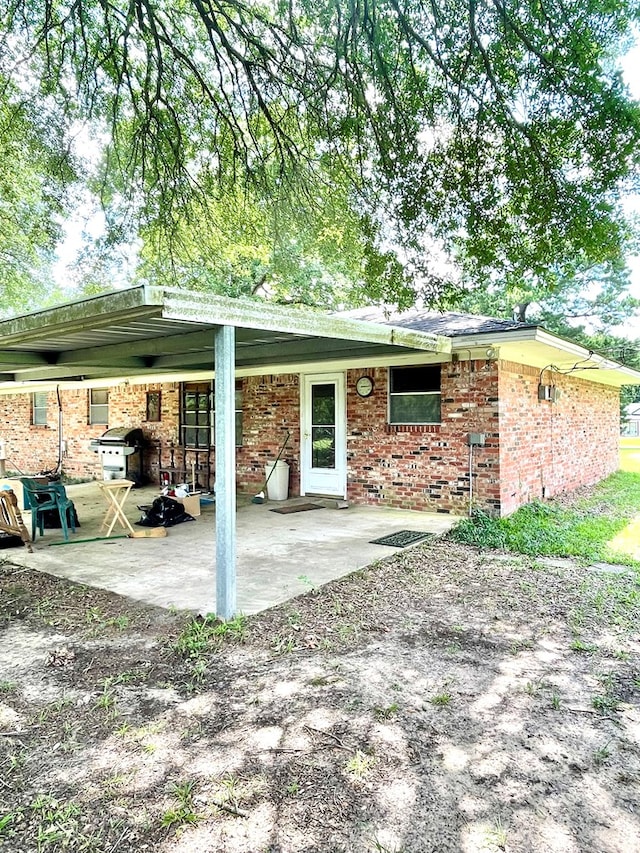 7203 Fm 326, Lufkin, TX 75901 - back of house featuring a patio and brick siding