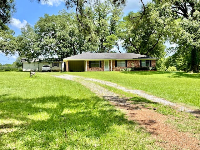 7203 Fm 326, Lufkin, TX 75901 - single story home with dirt driveway, an attached carport, and a front yard