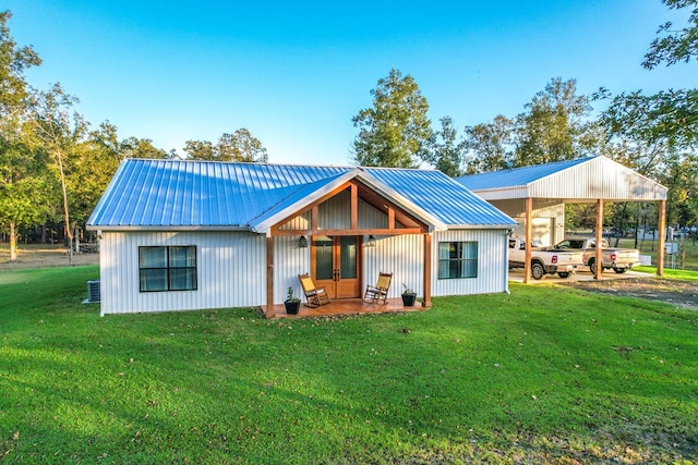 rear view of property featuring a yard