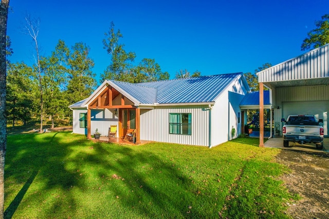 back of property featuring a lawn and a carport