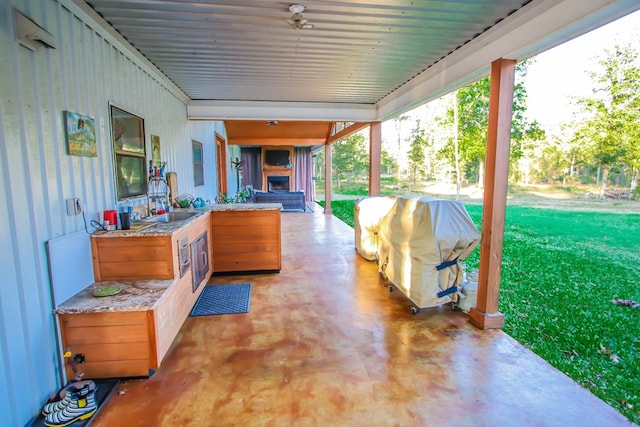 view of patio / terrace with area for grilling and a fireplace