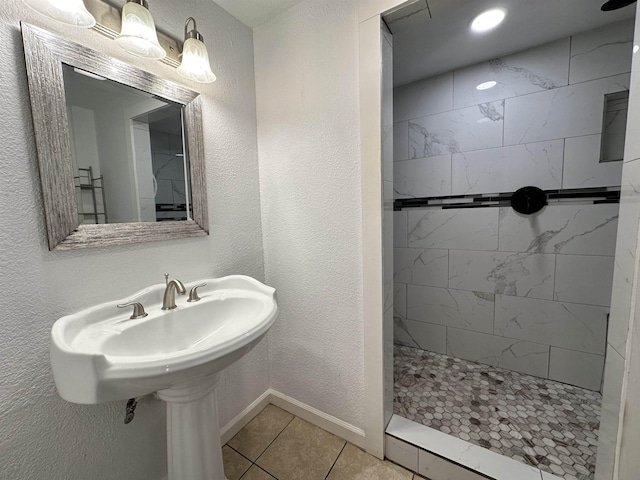 bathroom with tile patterned flooring and tiled shower