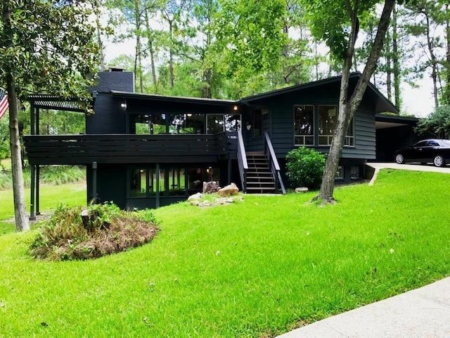 view of front of house with a deck and a front lawn