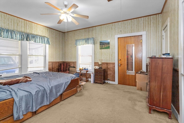 carpeted bedroom with ceiling fan and ornamental molding