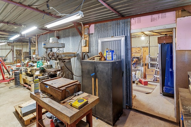 miscellaneous room with a workshop area and concrete floors