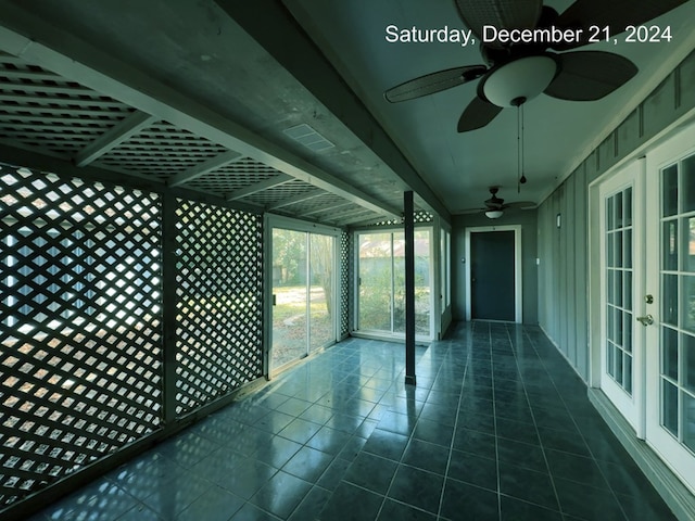 interior space with ceiling fan and french doors