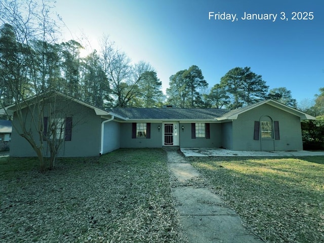 ranch-style home with a front lawn