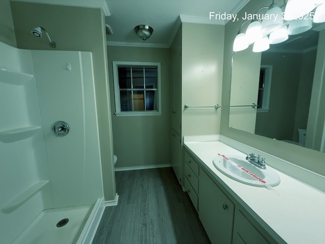 bathroom with walk in shower, crown molding, hardwood / wood-style floors, toilet, and vanity