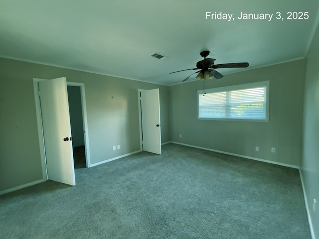 unfurnished bedroom with ceiling fan, light colored carpet, and crown molding