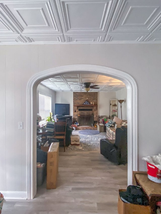 corridor featuring wooden walls, hardwood / wood-style floors, and coffered ceiling