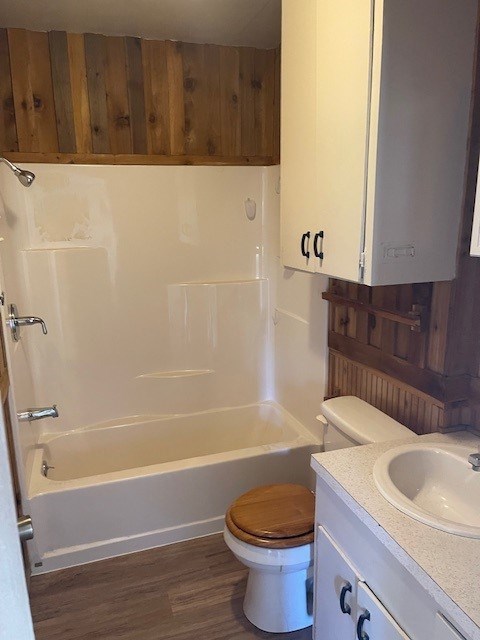 full bathroom featuring vanity, toilet, wood-type flooring, and shower / washtub combination