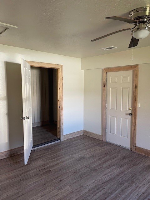 interior space with hardwood / wood-style floors, a textured ceiling, and ceiling fan