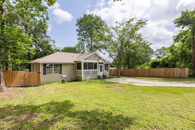 225 Jerri St, Lufkin, TX 75901 - back of house featuring a sunroom and roof with shingles