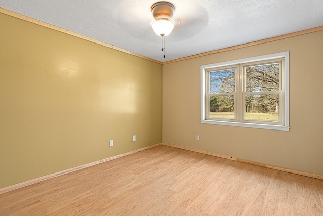 empty room with a textured ceiling and light wood-type flooring