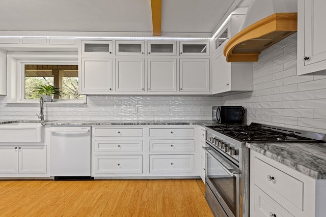 kitchen with white cabinetry, dishwasher, and high end range