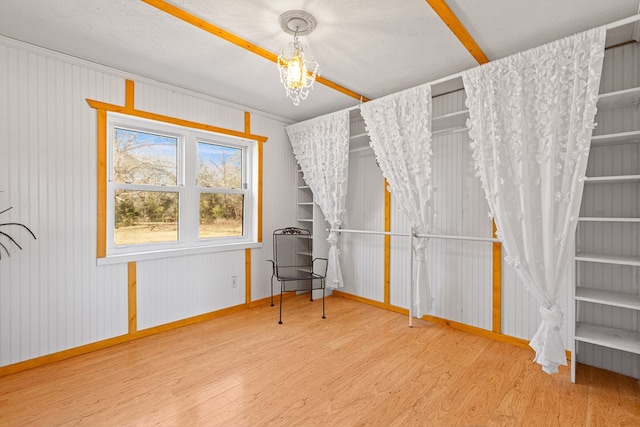 interior space featuring an inviting chandelier and hardwood / wood-style flooring