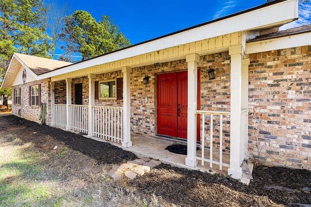 view of exterior entry with covered porch