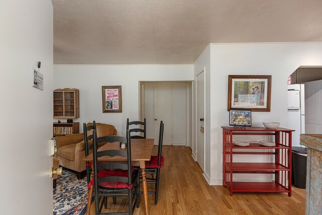 998 Winston 8 Ranch Rd, Lufkin, TX 75904 - dining space with wood finished floors and a textured ceiling