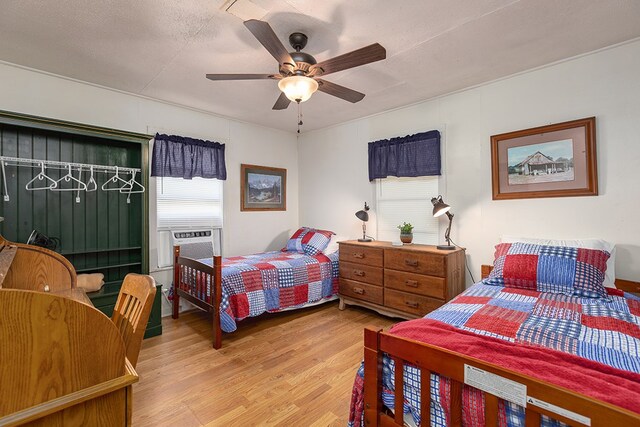 998 Winston 8 Ranch Rd, Lufkin, TX 75904 - bedroom with light wood-style flooring, ceiling fan, and cooling unit