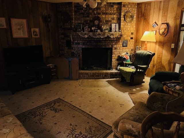 living room featuring a textured ceiling, a fireplace, and wood walls