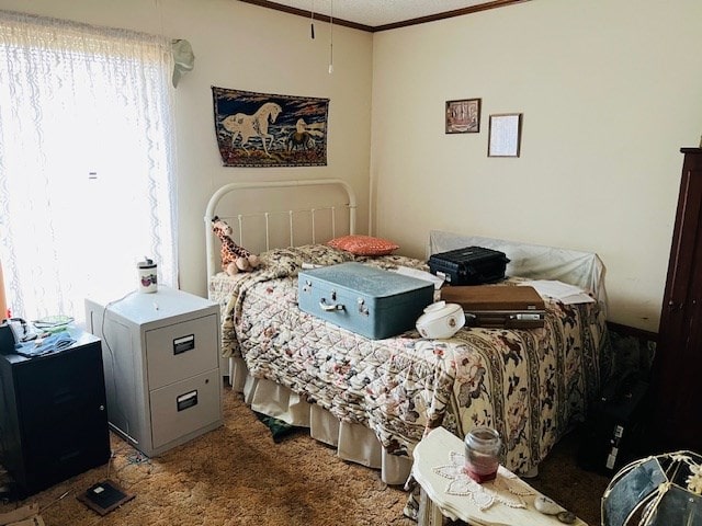 bedroom featuring ornamental molding and carpet flooring