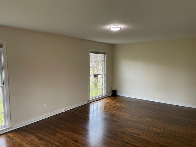 empty room featuring dark hardwood / wood-style flooring