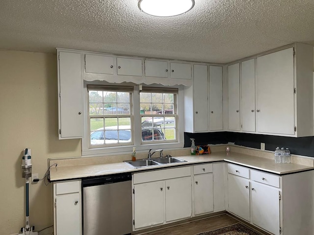 kitchen featuring dishwasher, white cabinets, and sink