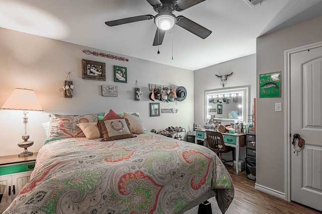 bedroom with hardwood / wood-style flooring and ceiling fan