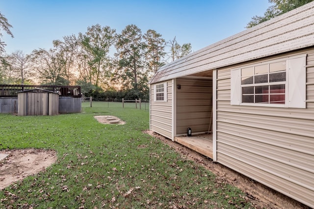 yard at dusk with a storage shed