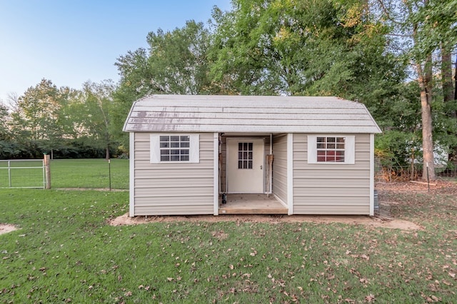 view of outdoor structure featuring a lawn