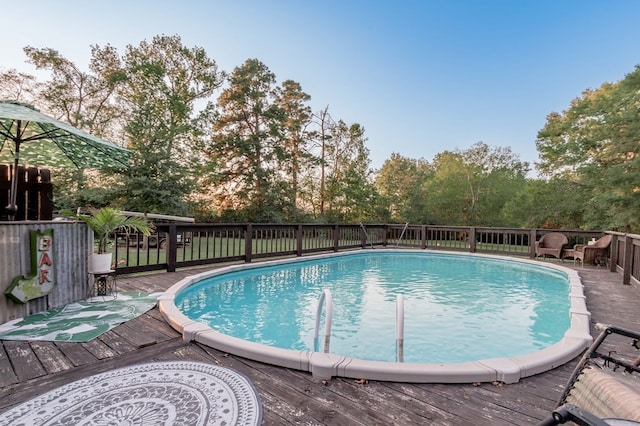 view of swimming pool with a wooden deck