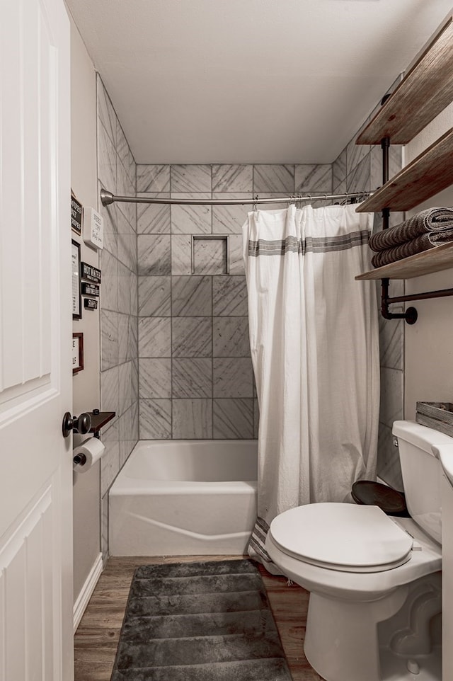 bathroom featuring wood-type flooring, toilet, and shower / bath combo with shower curtain