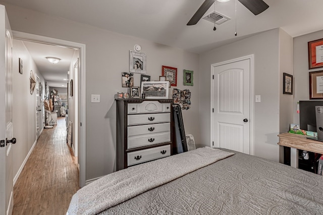 bedroom with ceiling fan and wood-type flooring