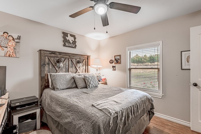 bedroom featuring ceiling fan and dark wood-type flooring