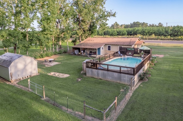 view of swimming pool featuring a storage shed and a lawn