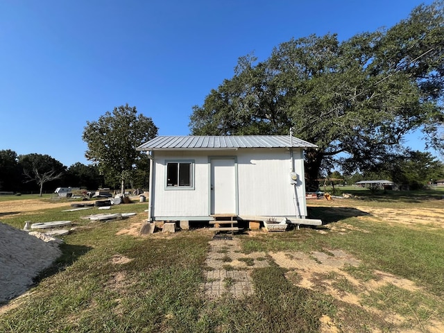 view of outbuilding with a yard