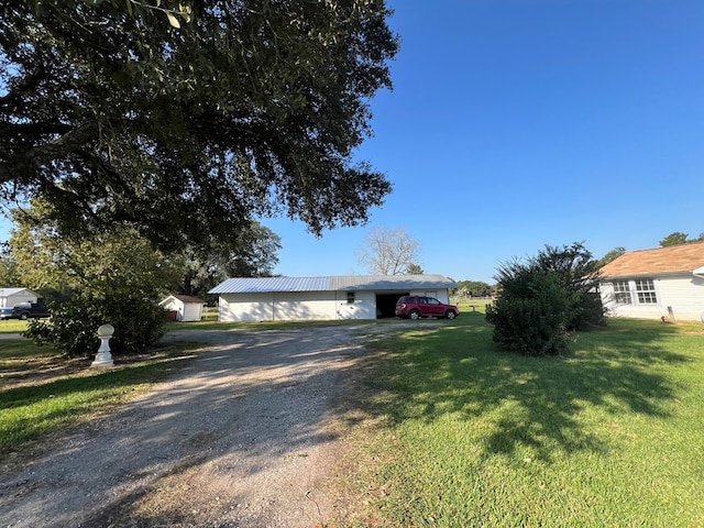 view of front of home featuring a front yard and an outbuilding