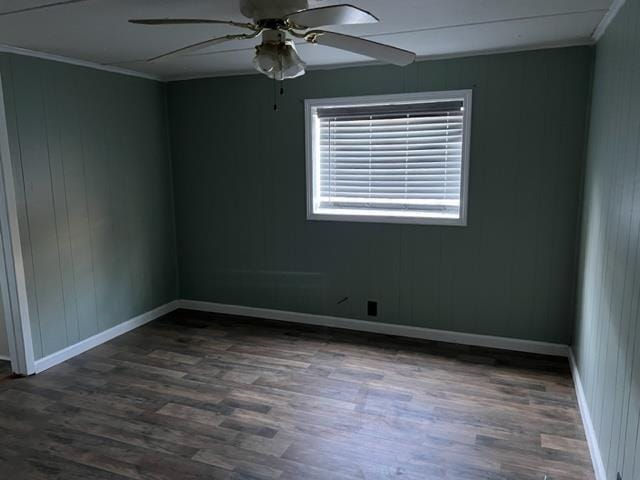 unfurnished room featuring ceiling fan, ornamental molding, and dark wood-type flooring