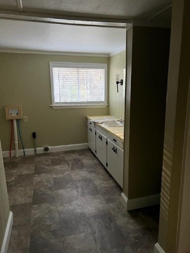 bathroom with vanity and ornamental molding