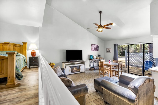 living room featuring high vaulted ceiling, ceiling fan, and light wood-type flooring