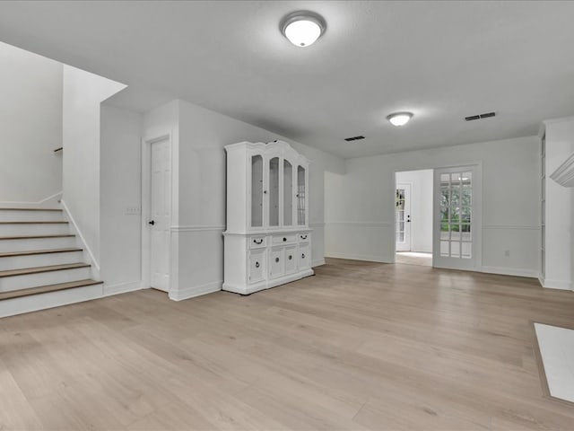 107 Bending Oak Dr, Lufkin, TX 75904 - unfurnished living room with light wood-style flooring and stairs
