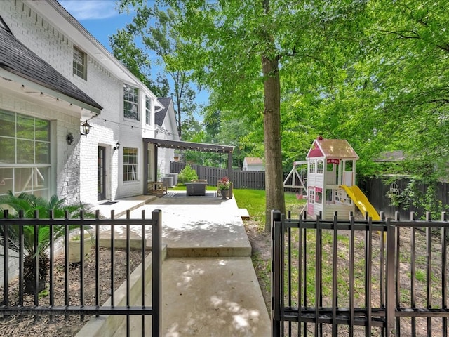 107 Bending Oak Dr, Lufkin, TX 75904 - fenced backyard featuring a playground and a patio area