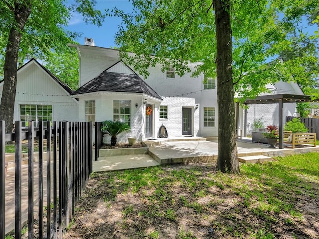 107 Bending Oak Dr, Lufkin, TX 75904 - view of front of home featuring a patio, brick siding, and a chimney